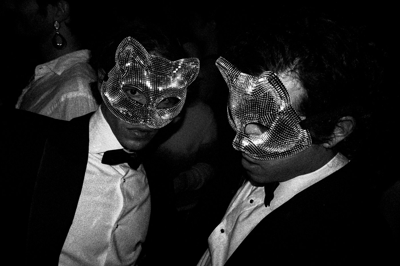 two men wearing masks at party