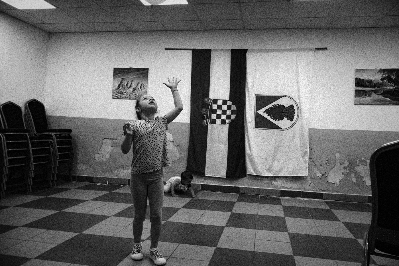 two children playing infornt of the croatian flag