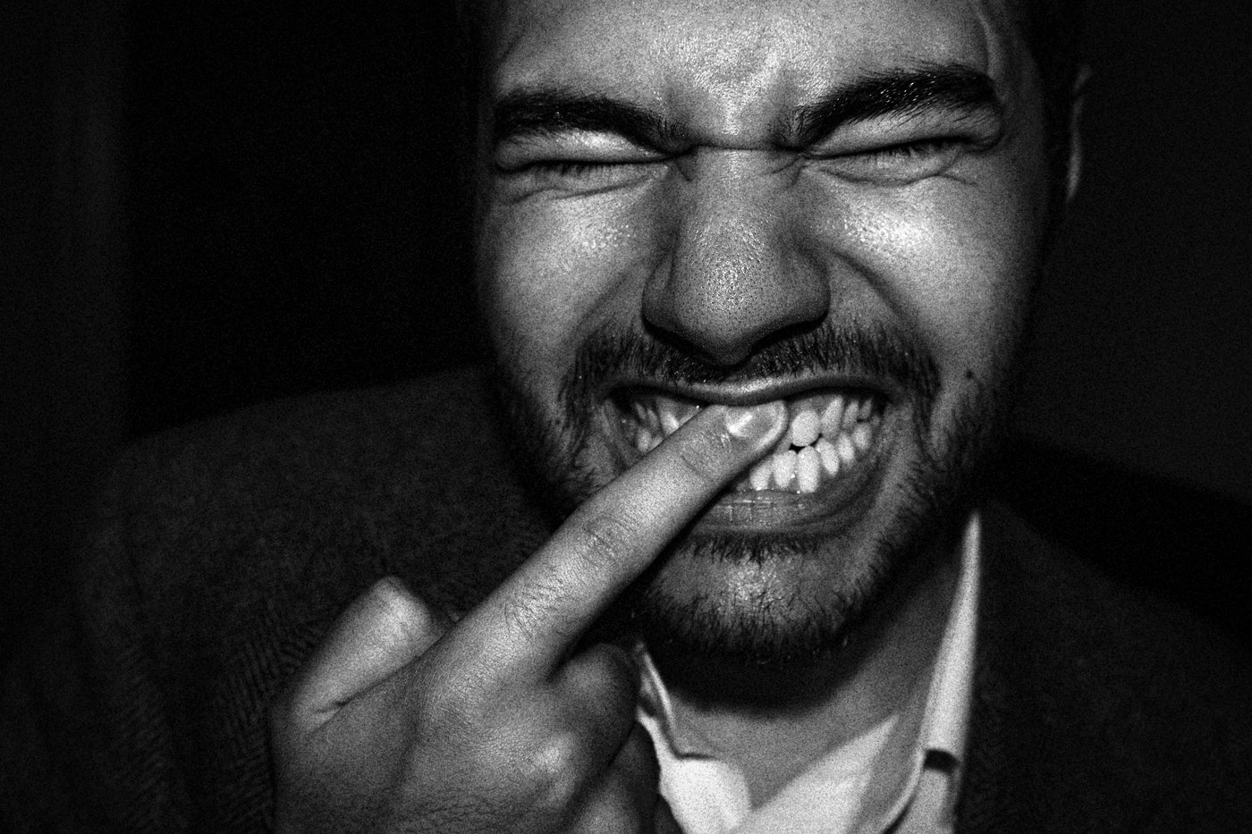 man rubbing his teeth