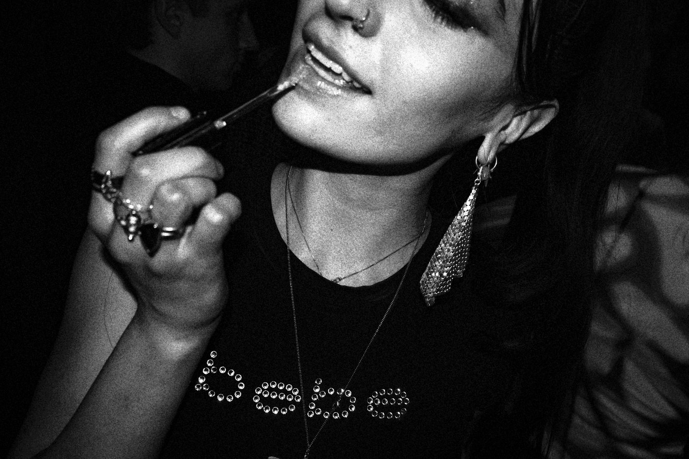 a woman applying lip gloss