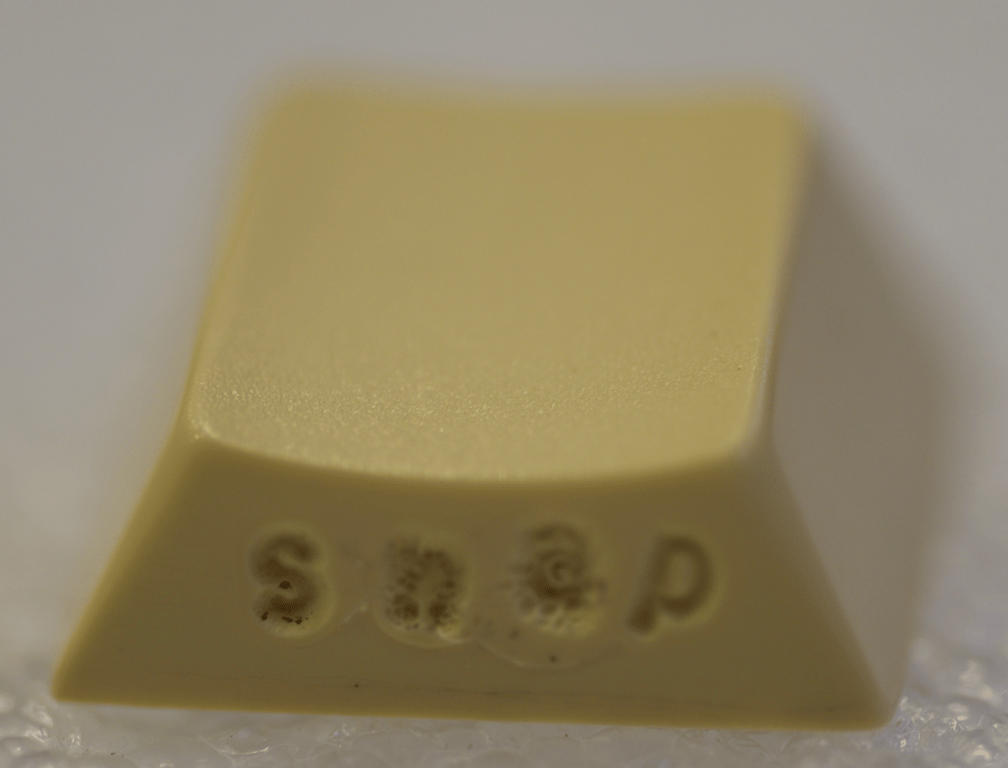Proto FN GMK Plum Color sample with "boom" melted in