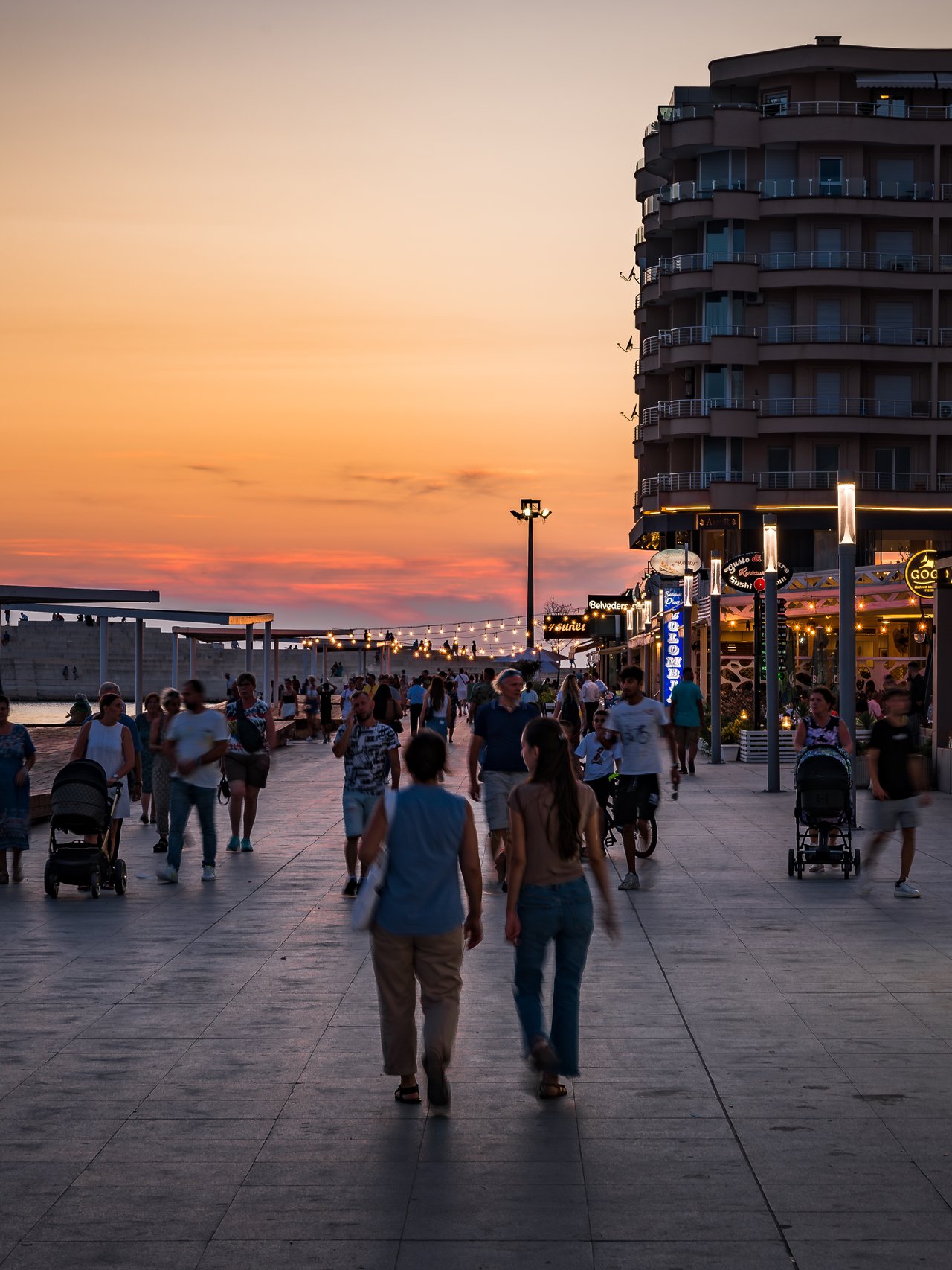 People walking along the promenade on a summer evening in Durres, Albania