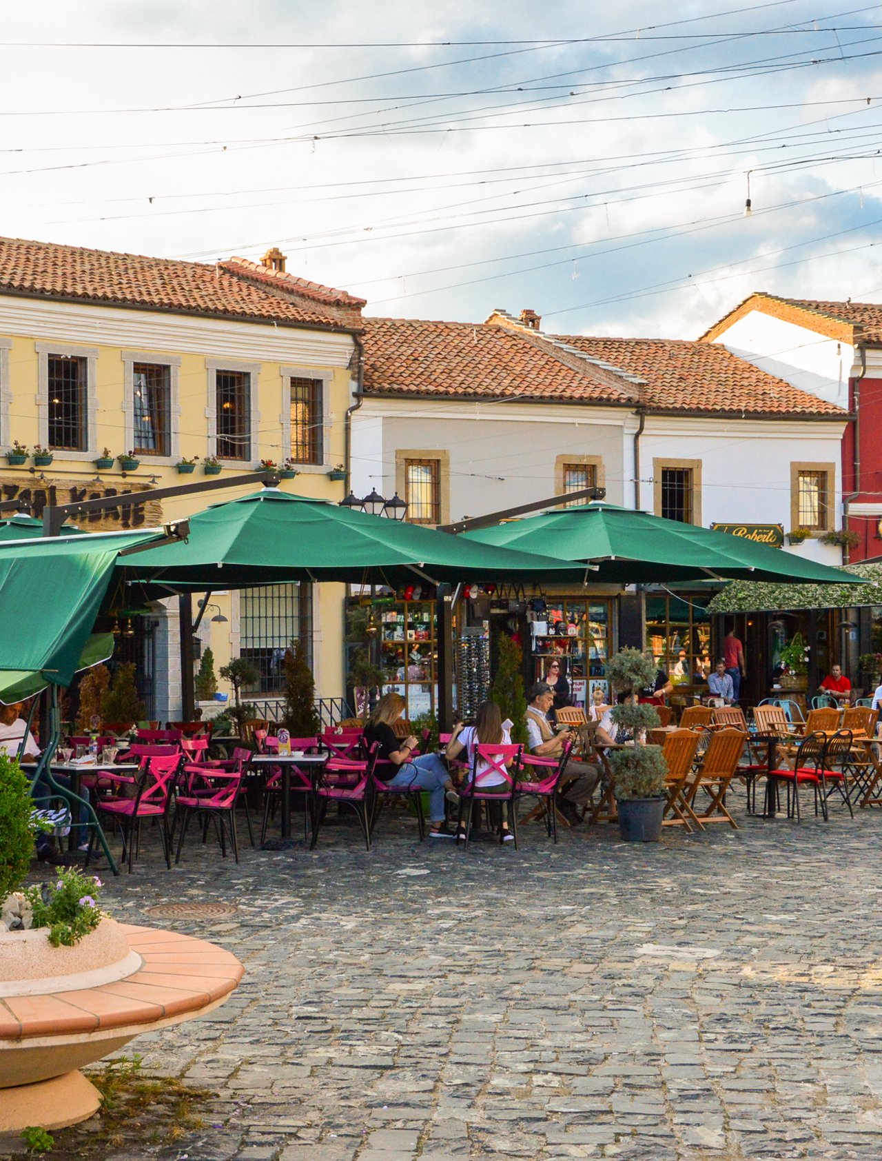 People hanging out at cafes at the Old Bazaar of Korca