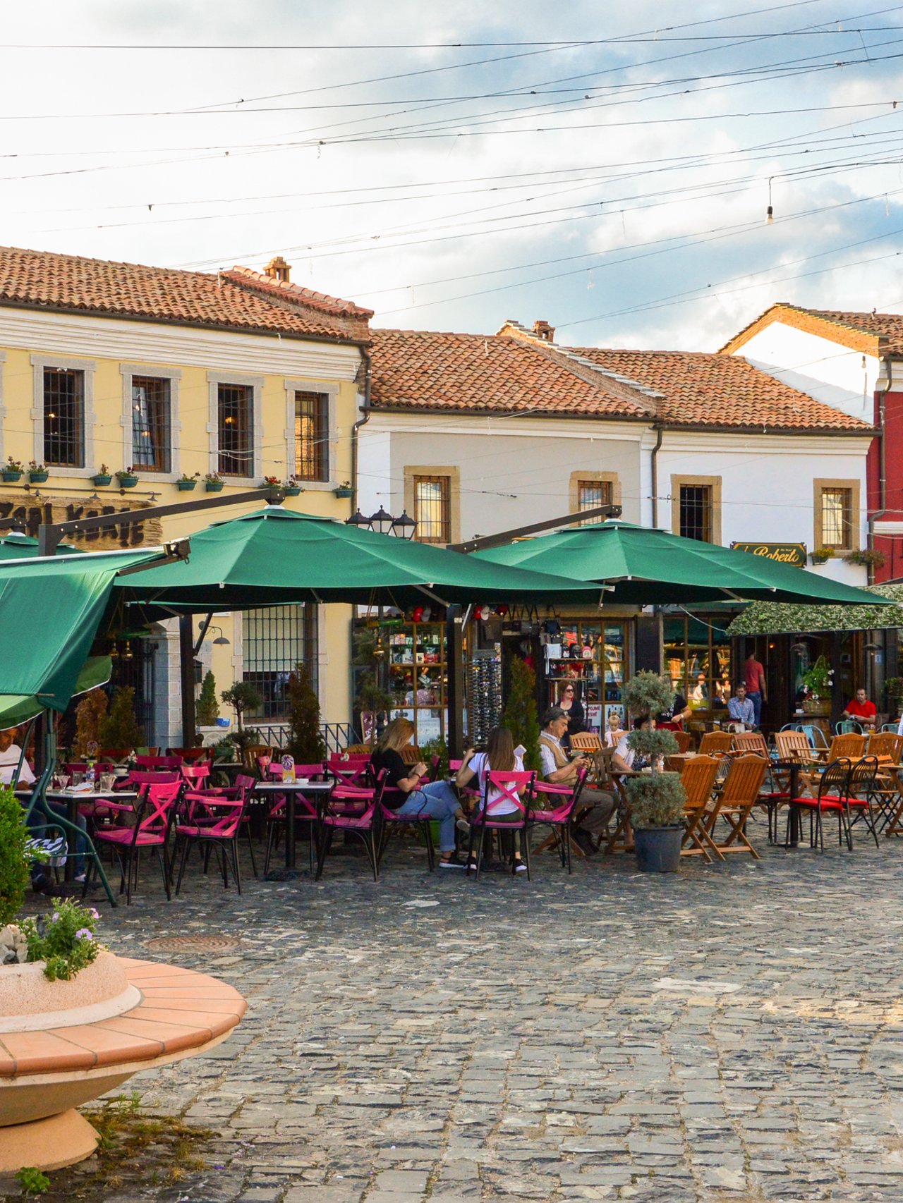 People hanging out at cafes at the Old Bazaar of Korca