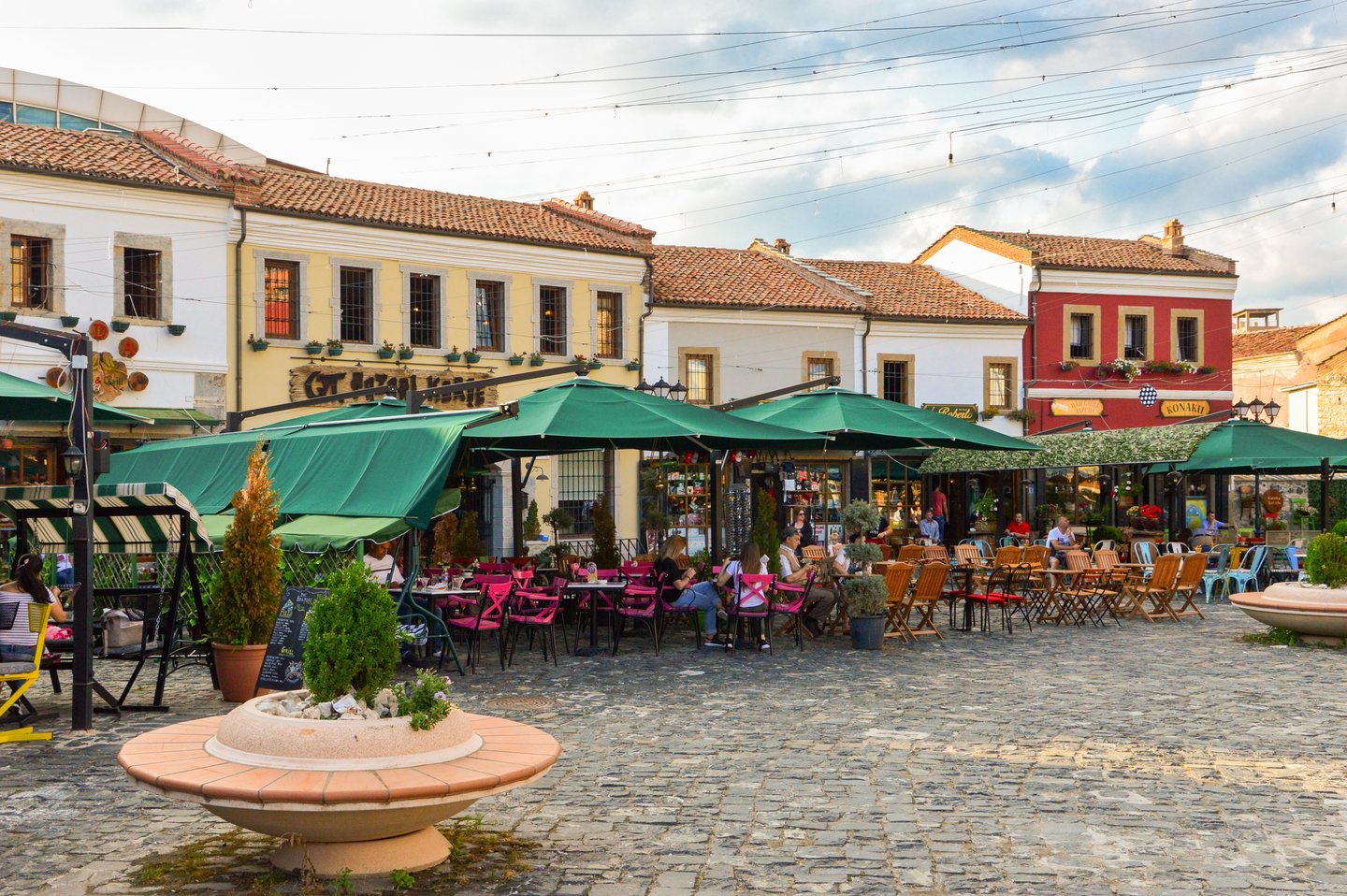 People hanging out at cafes at the Old Bazaar of Korca