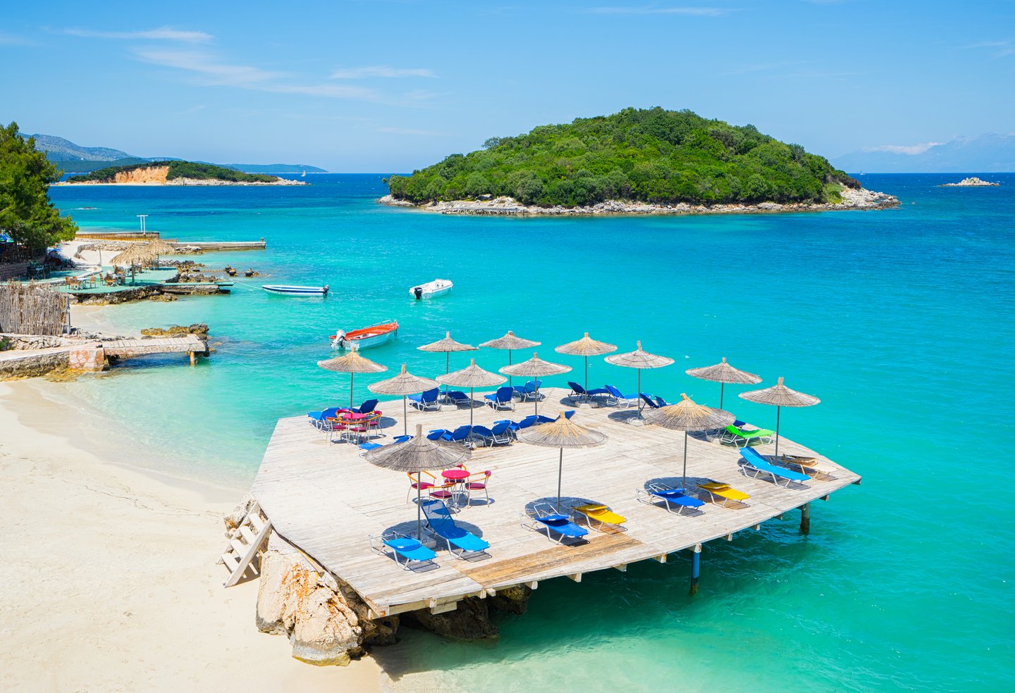 Umbrellas and deckchairs on the beach in Ksamil, Albania