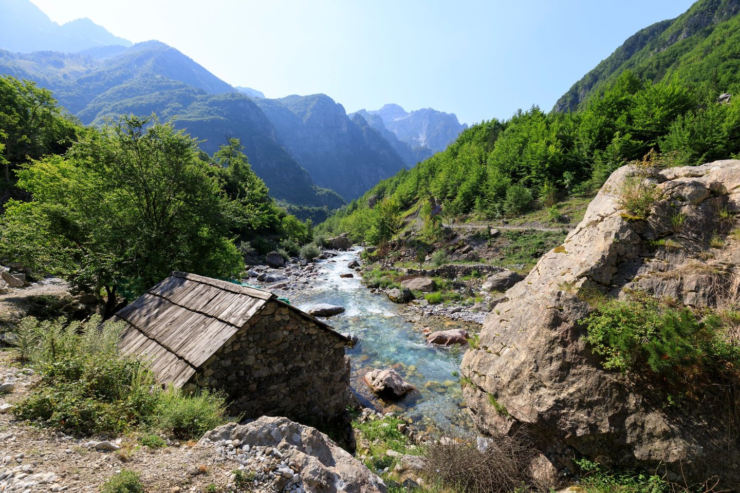 Valley of Theth with a river and an old house in the dinaric alps in Albania