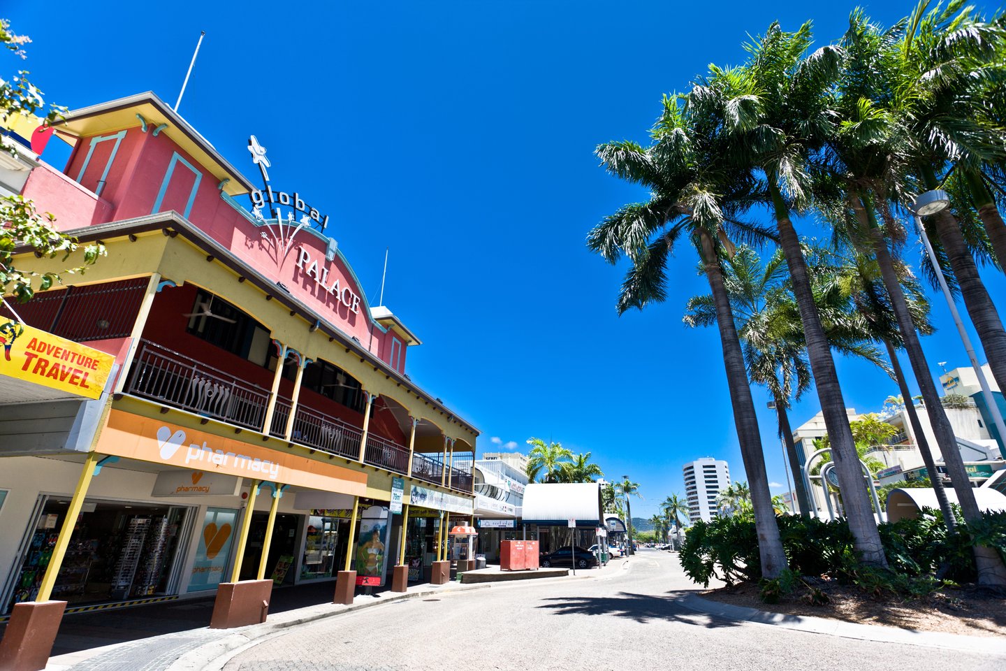 A colourful building and palm trees in Cairns, Australia.