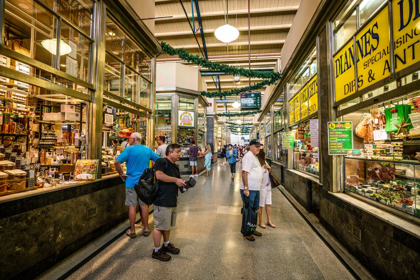 People wandering through the food section of the Queen Victoria Market in Melbourne.