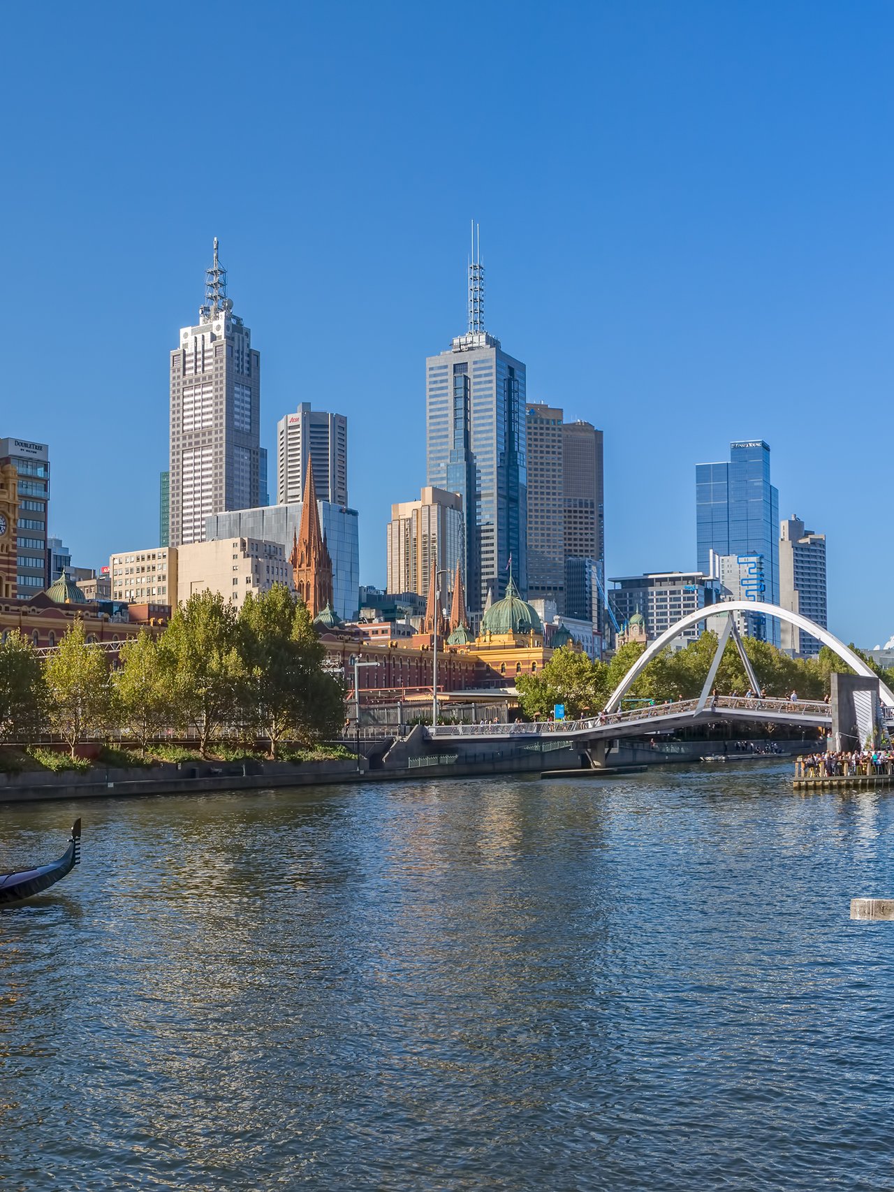 A gondola in the Yarra River with Melbourne city views in the background.