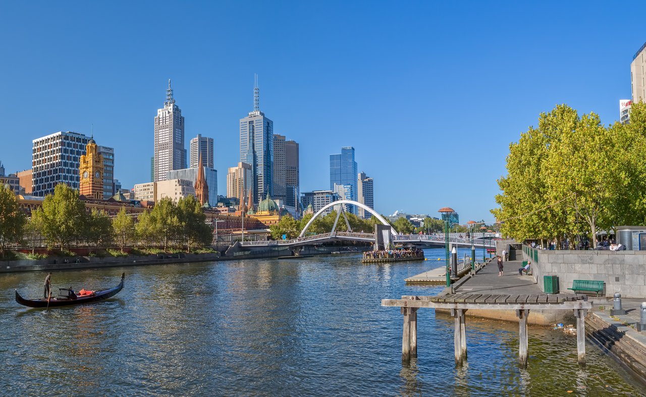 A gondola in the Yarra River with Melbourne city views in the background.