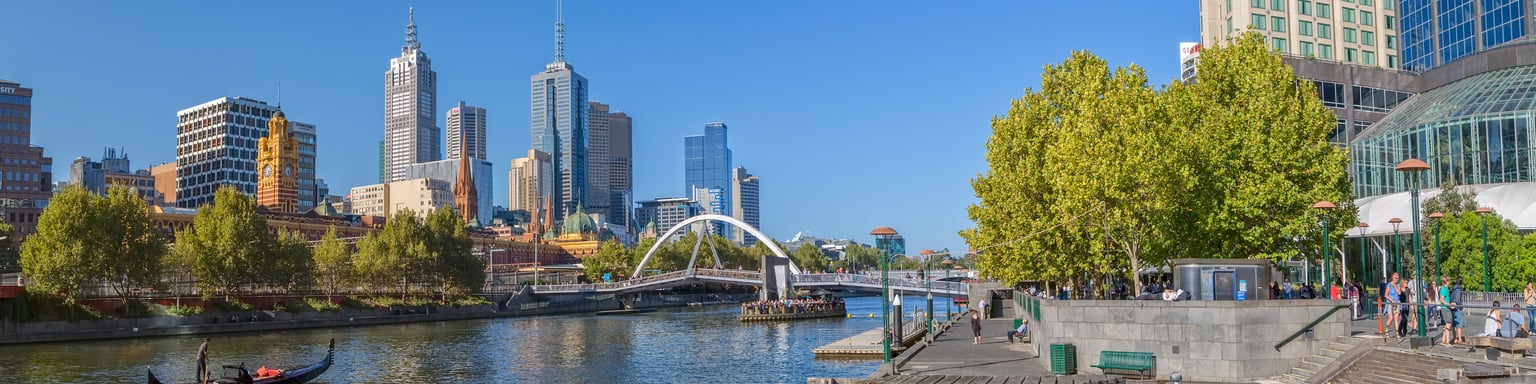 A gondola in the Yarra River with Melbourne city views in the background.