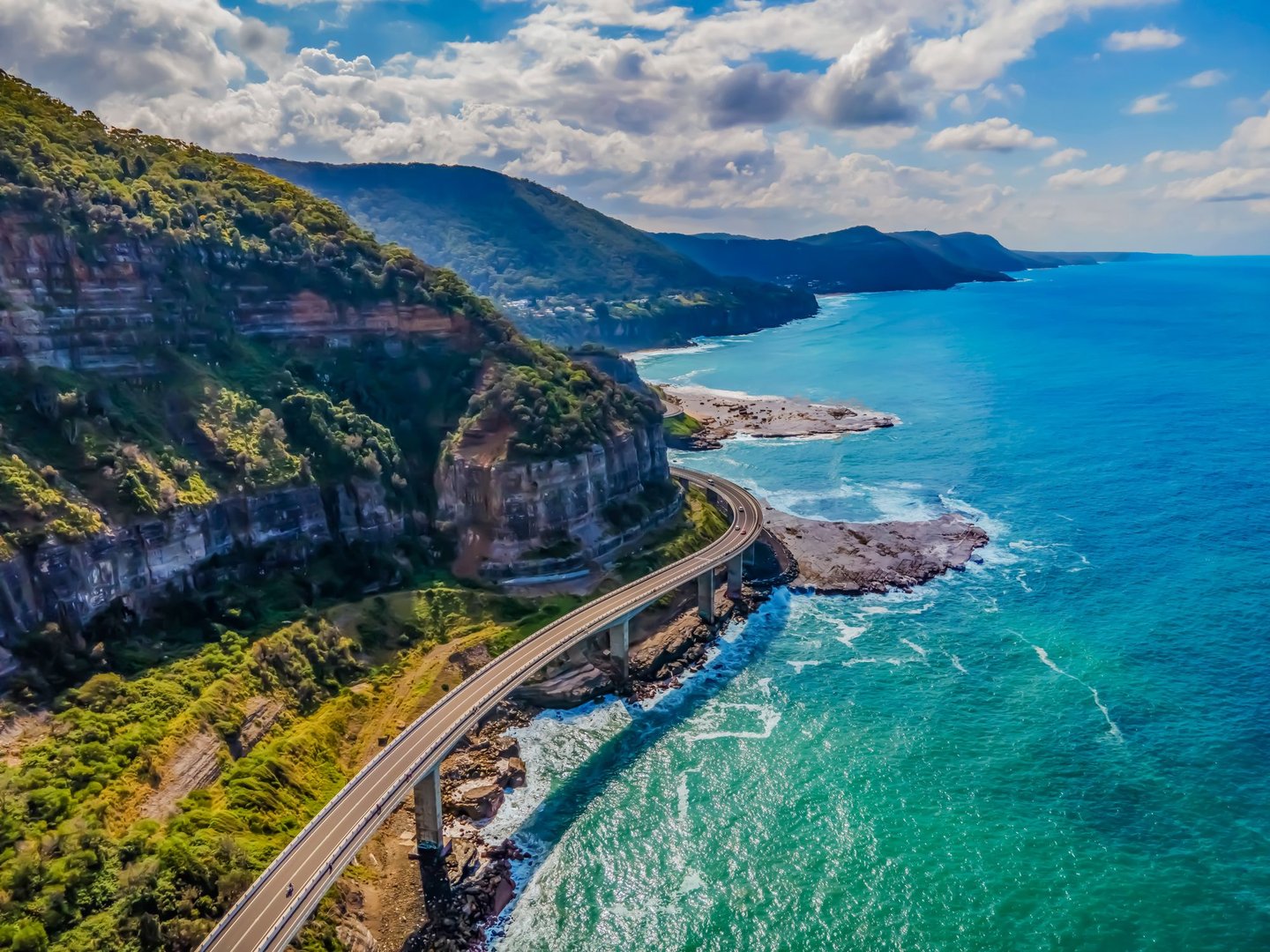 An aerial view of Sea Cliff Bridge and the stunning coastline in New South Wales, Australia