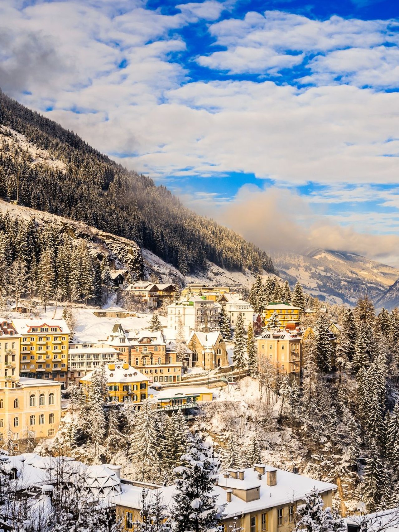 Snow on the nbuildings and trees in Bad Gastein in winter.