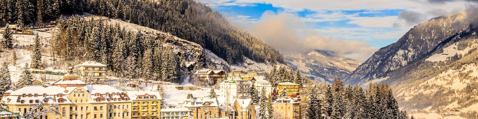 Snow on the nbuildings and trees in Bad Gastein in winter.