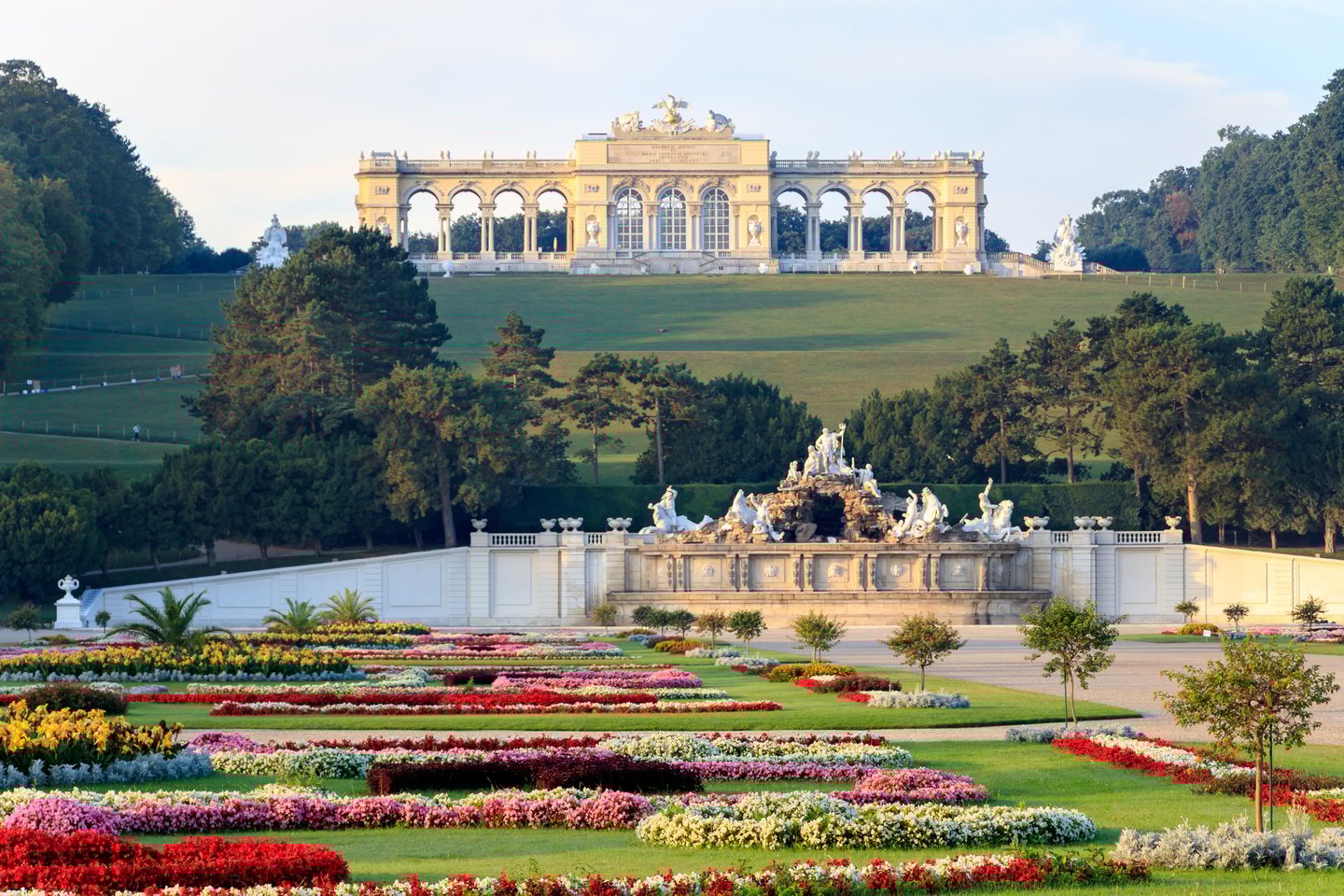 Schnbrunn Palace overlooking a garden with colourful flowers.