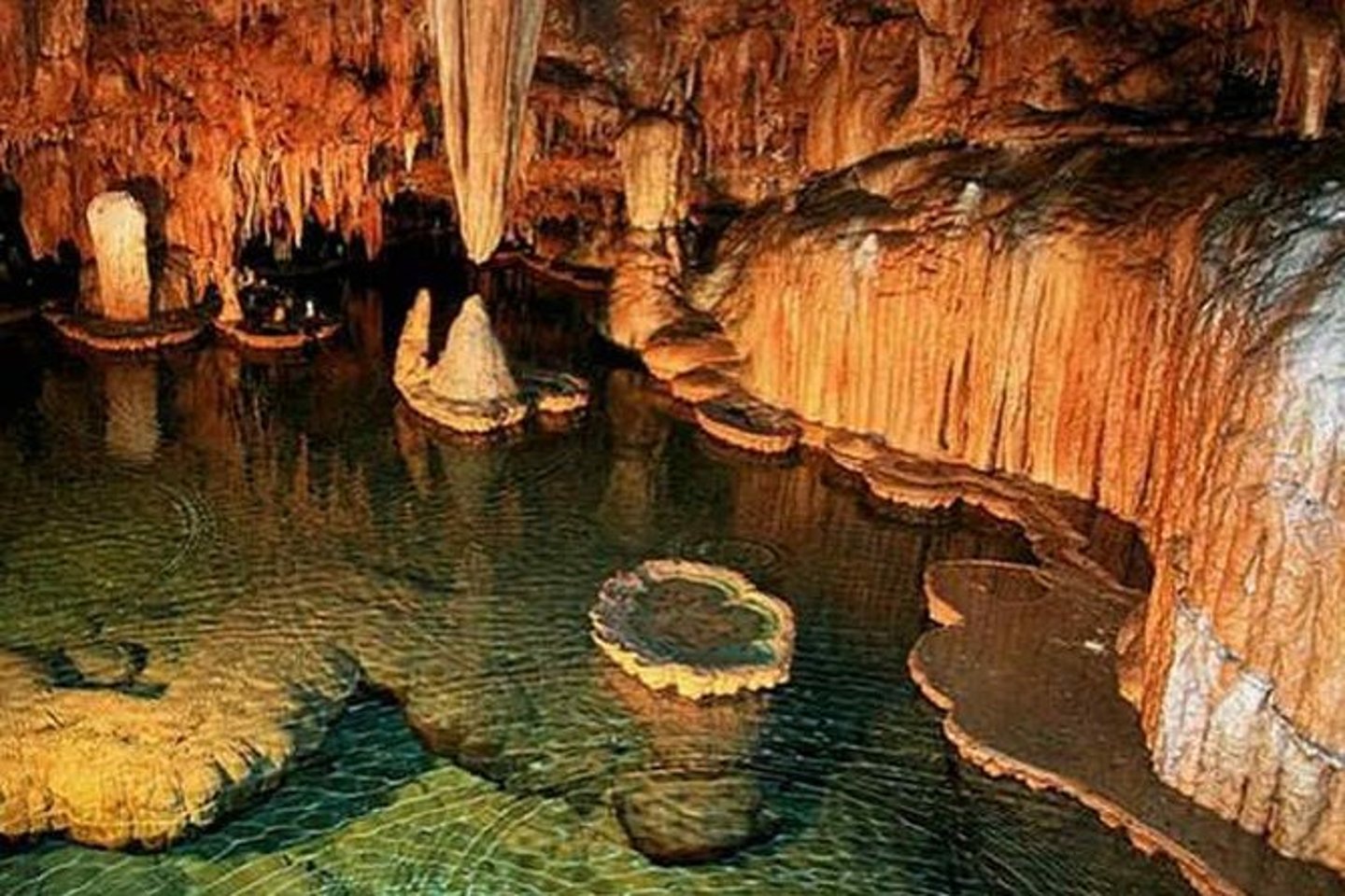 Stalactites hanging over the underground river in the ATM Cave in Belize