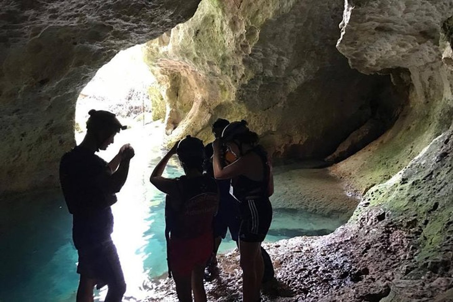 Visitors standing near the opening of the ATM Cave in Belize