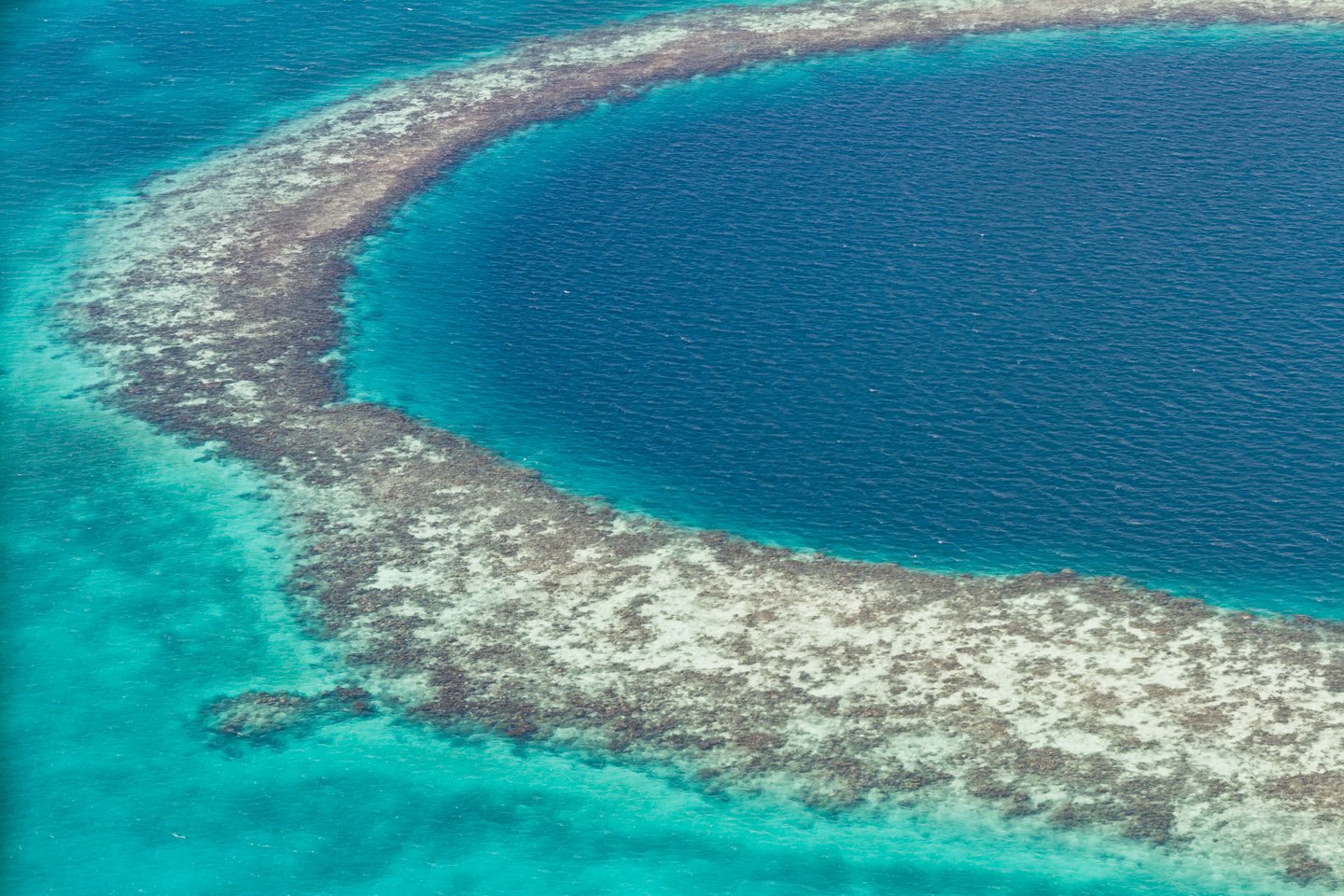 The changing colours of the sea surrounding the Great Blue Hole in Belize