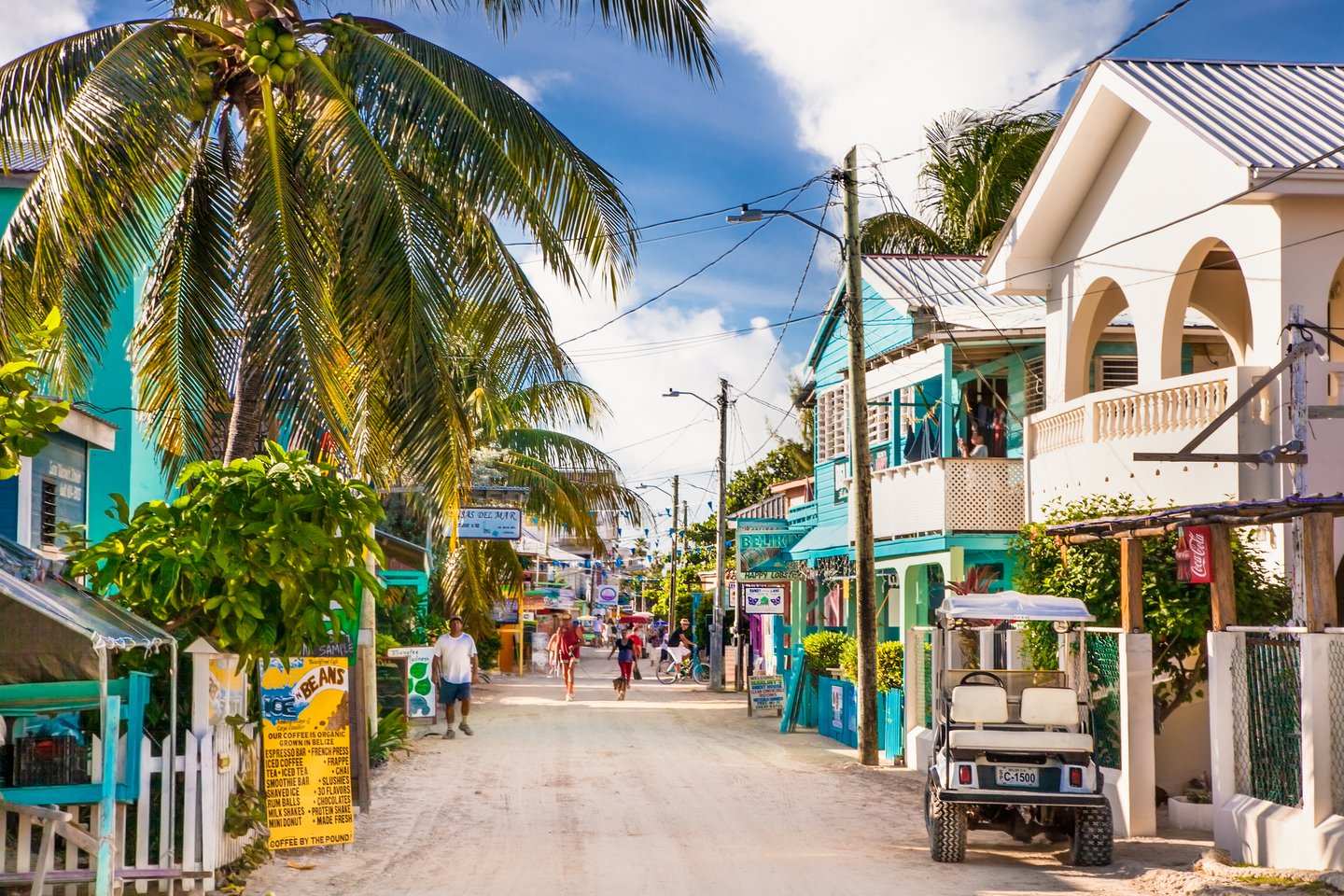 People walking down Playa Asuncion Street in Caye Caulker, Belize