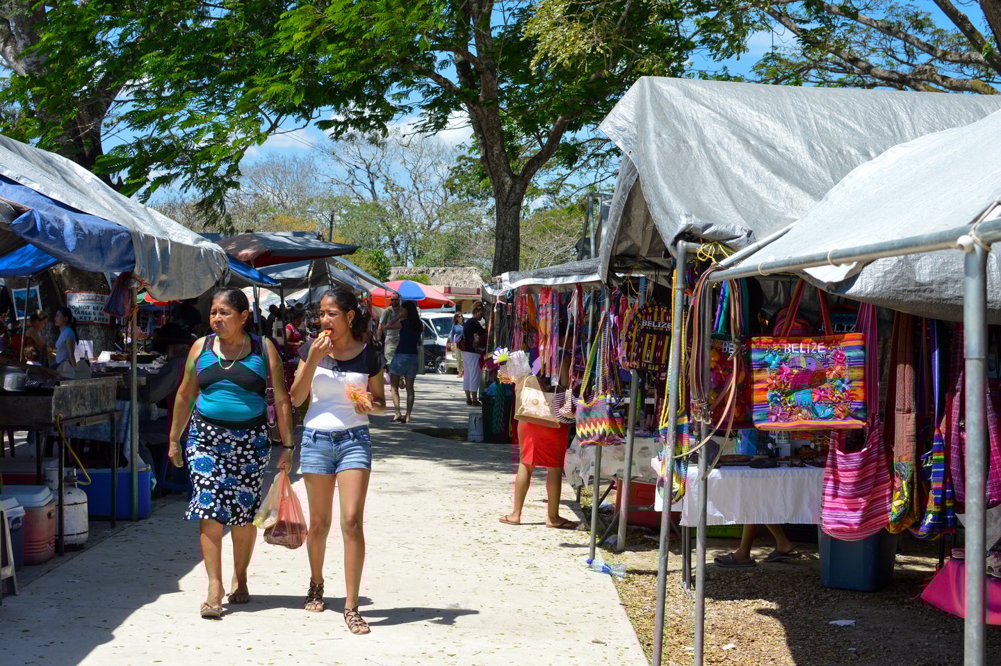 Stalls and people shopping at a market in San Ignacio, Belize