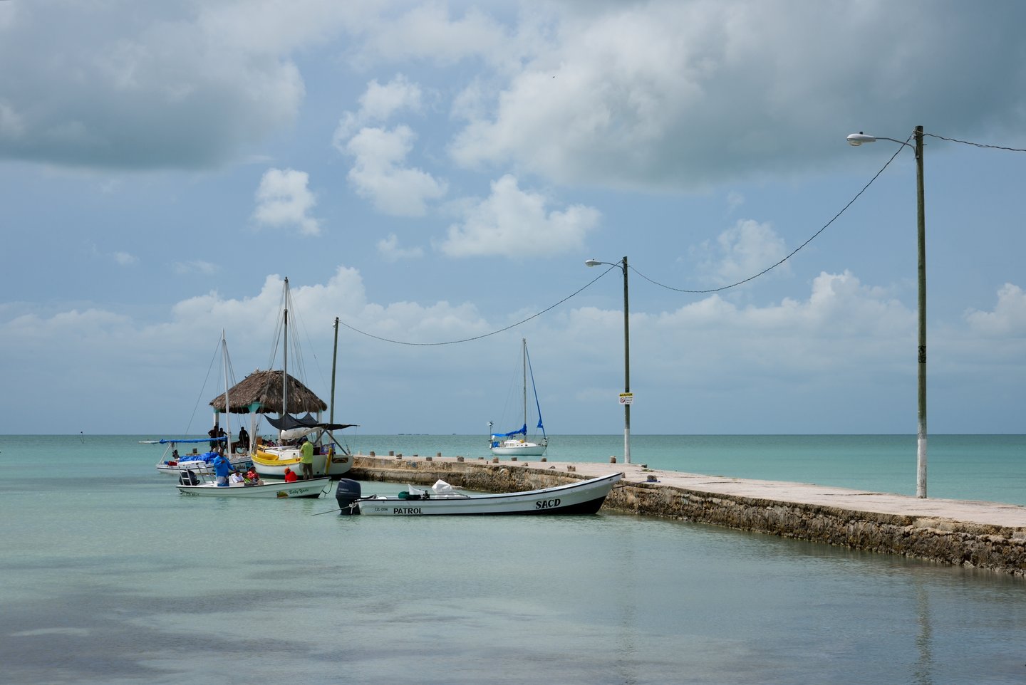 Fishing boats moored at a wharf in the village of Sarteneja, in Northern Belize