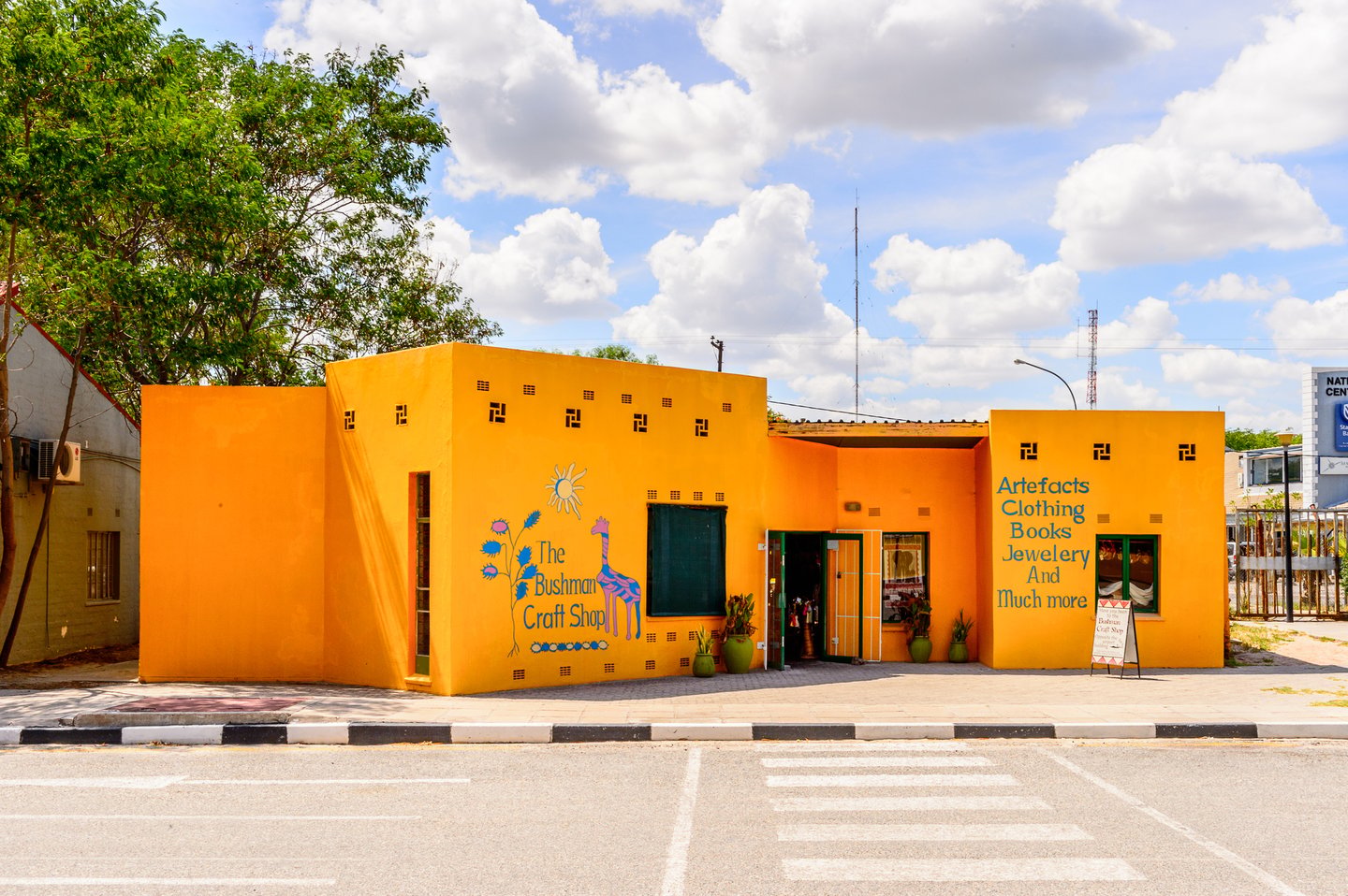 Craft shops in a bright yellow building in Maun, Botswana