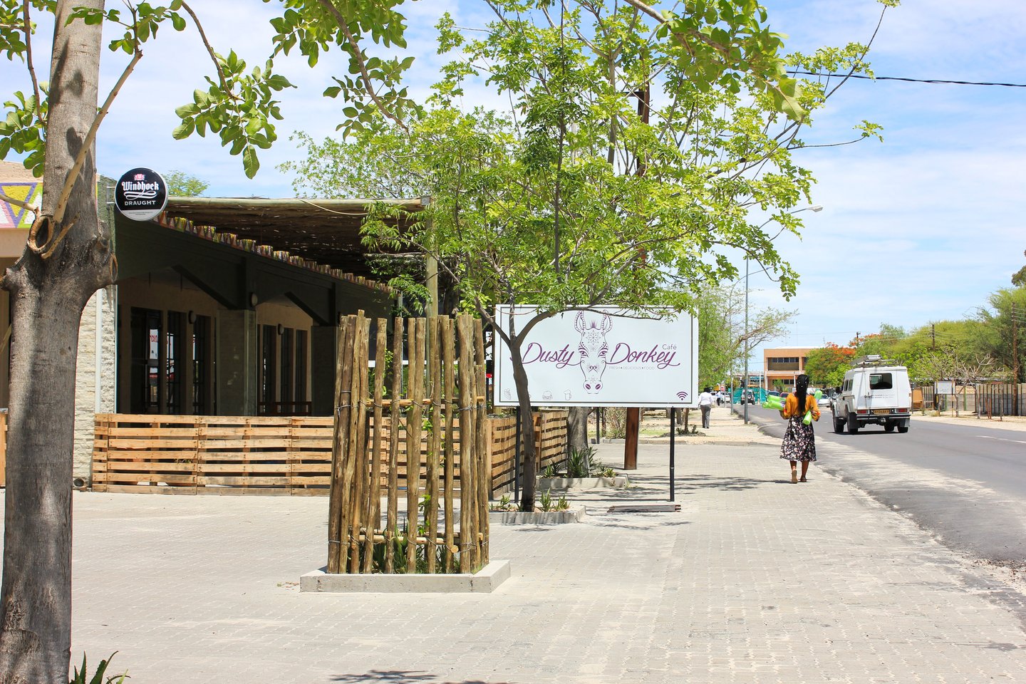 A pub and trees along a street in Maun, Botswana