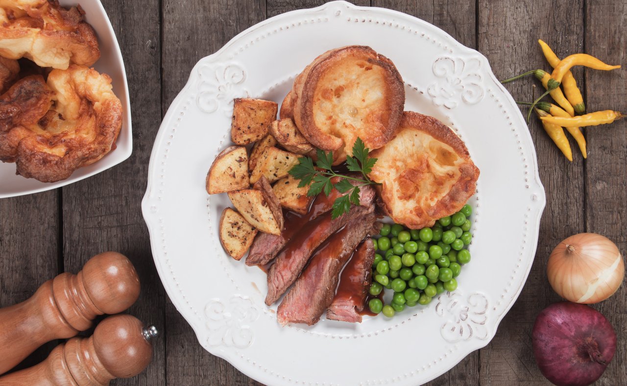 A full roast dinner with Yorkshire puddings, peas and potatoes