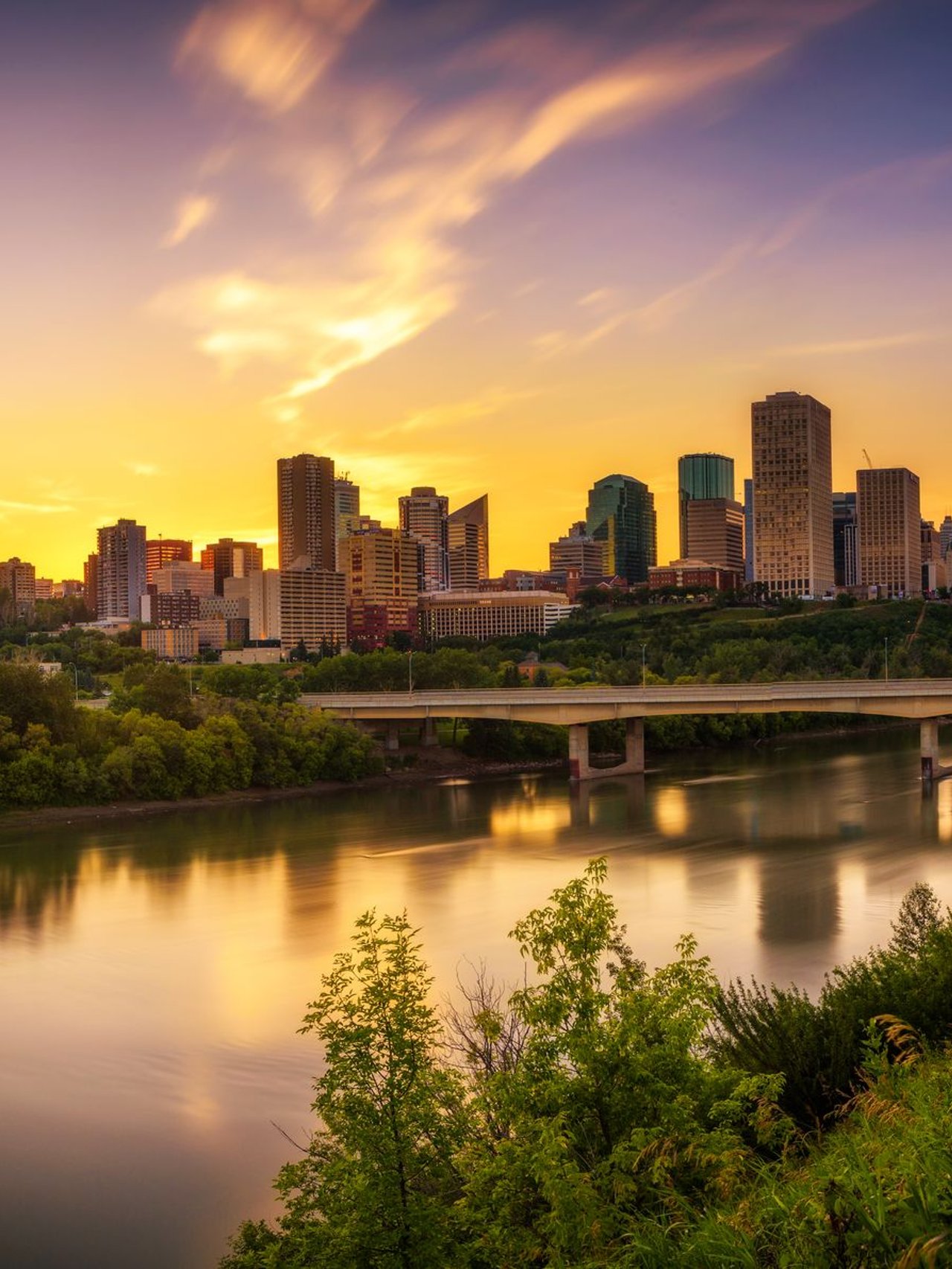 Looking at the Edmonton skyline across the river at sunset