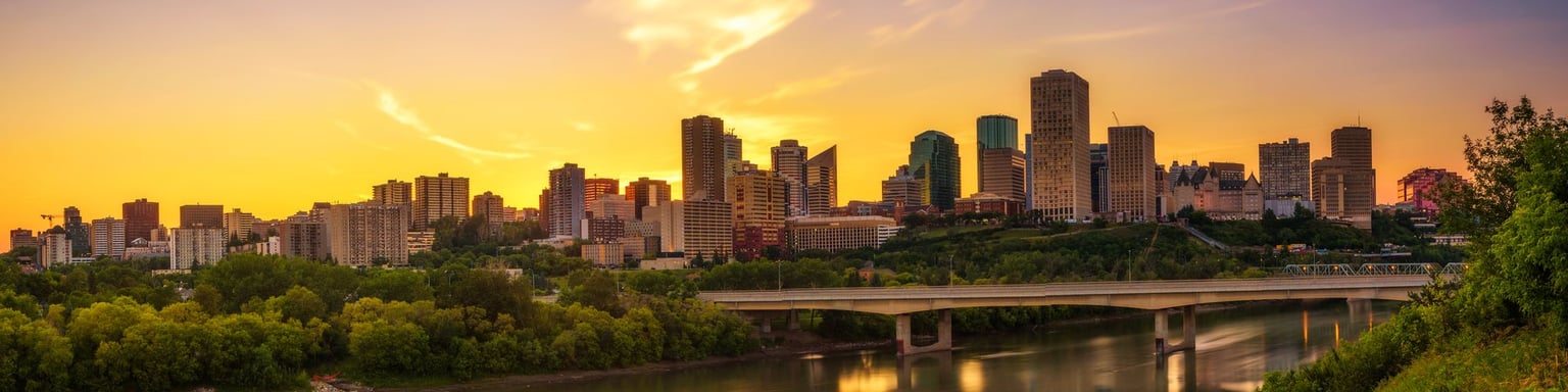 Looking at the Edmonton skyline across the river at sunset