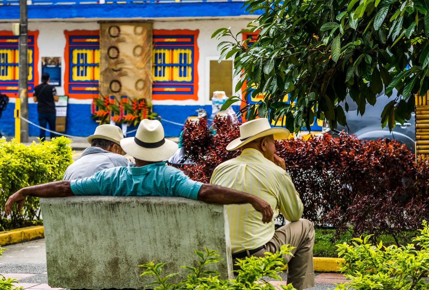 Three men sitting on a bench in Salento, Colombia