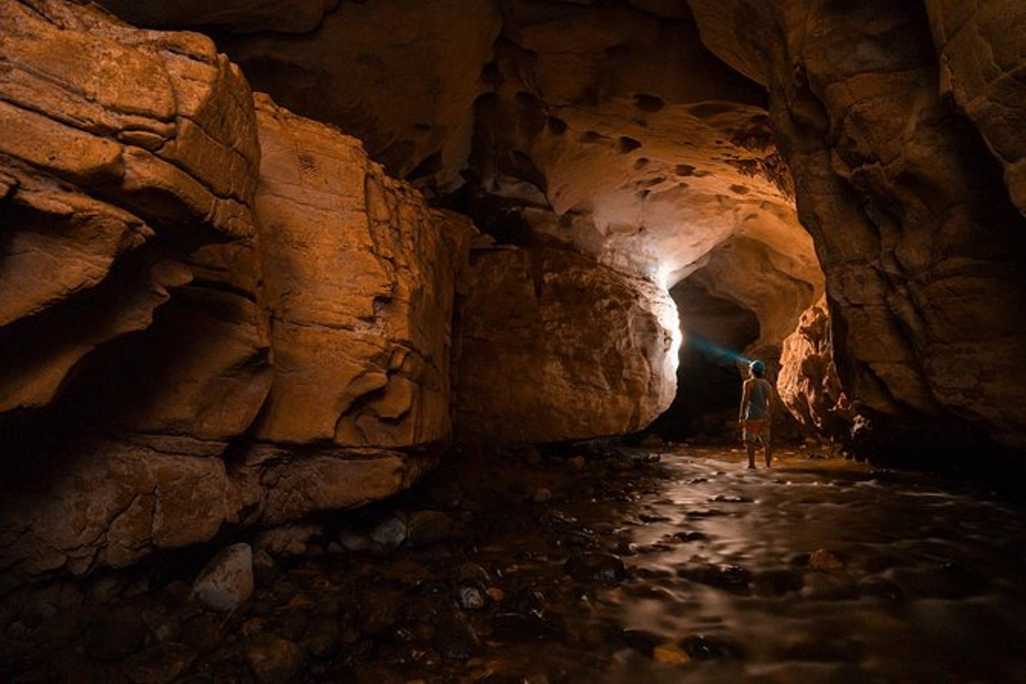 A man with a headtorch in the Venado Caves