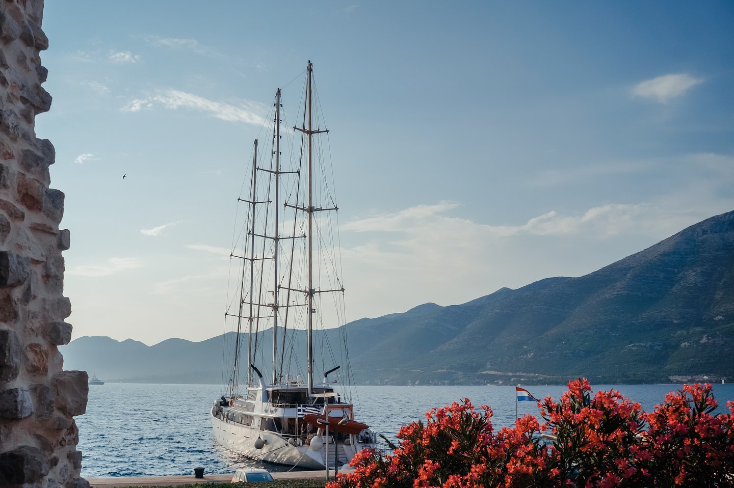 Harbour view from Korcula with pink flowers in foreground