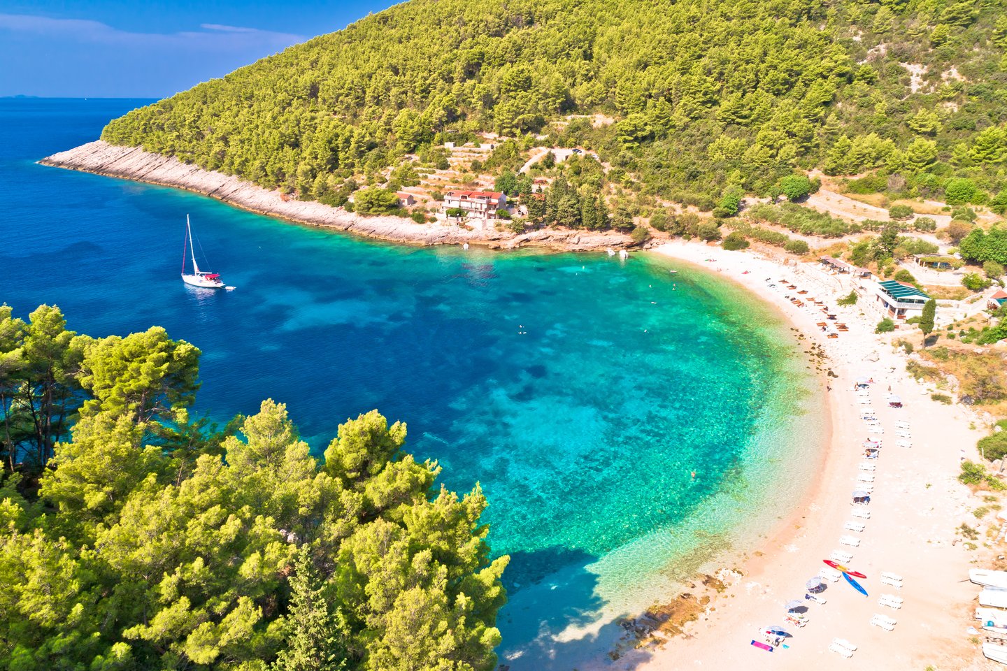 An aerial view of the turquoise water and beach in Pupnatska Luka cove, Korcula