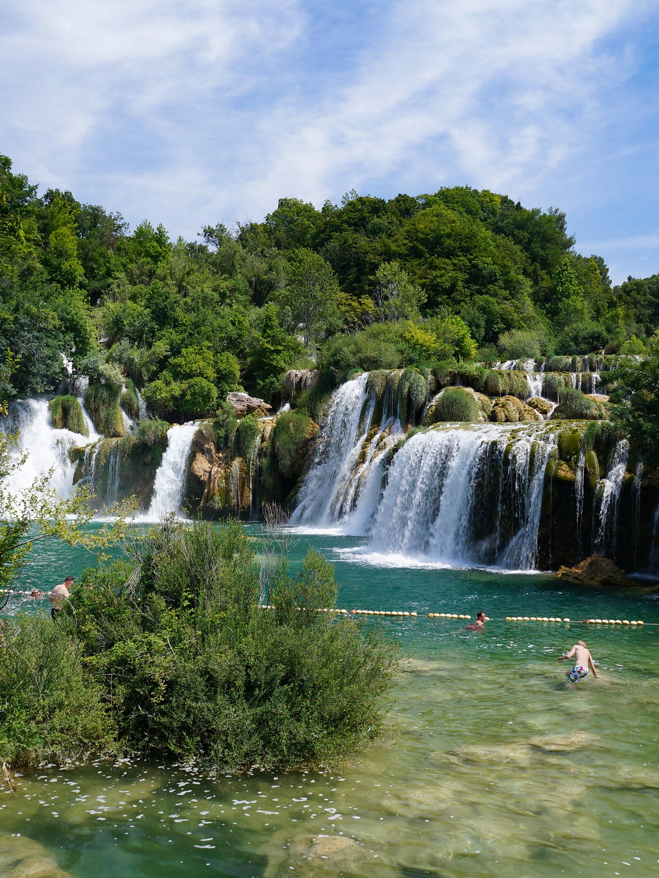 Swimming beneath the waterfalls in Krka National Park