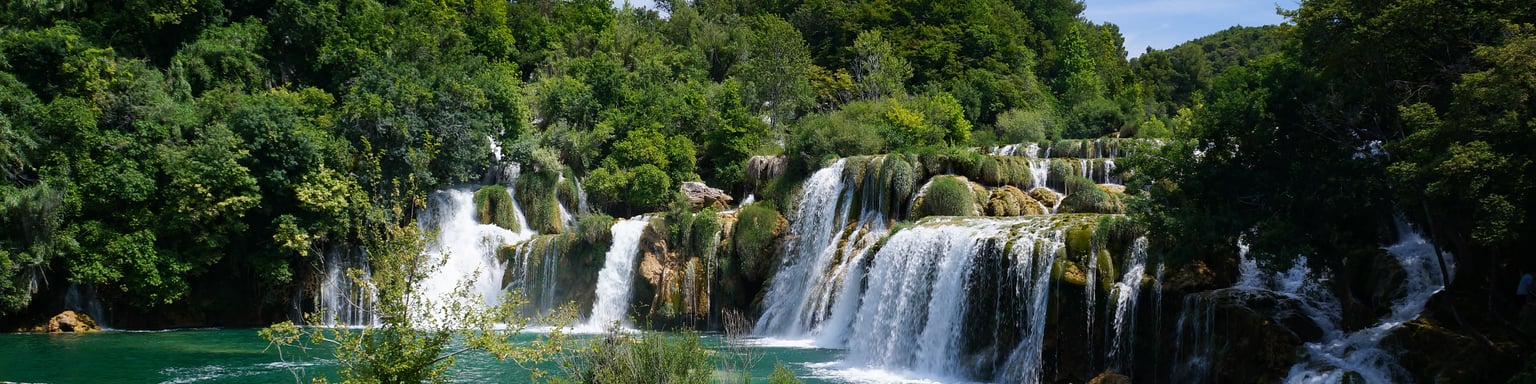 Swimming beneath the waterfalls in Krka National Park