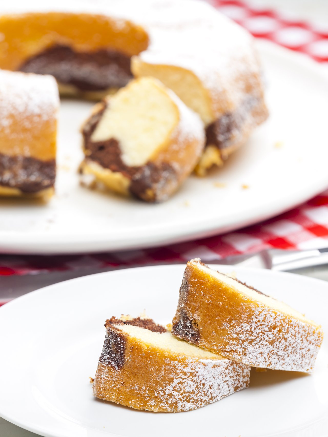Slices of babovka with the cake in the background