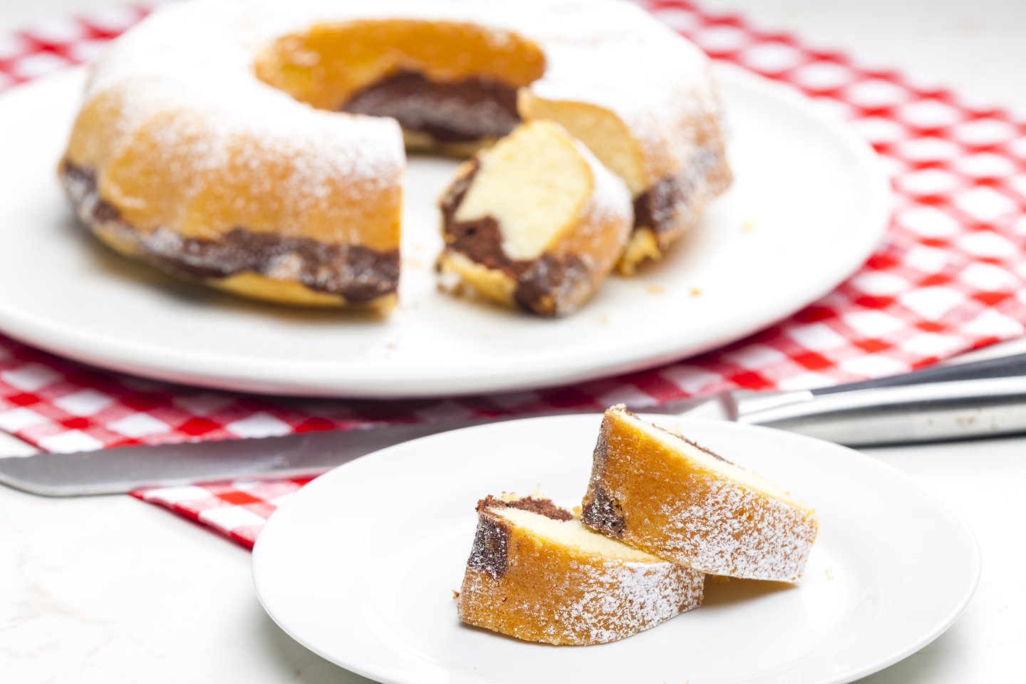 Slices of babovka with the cake in the background