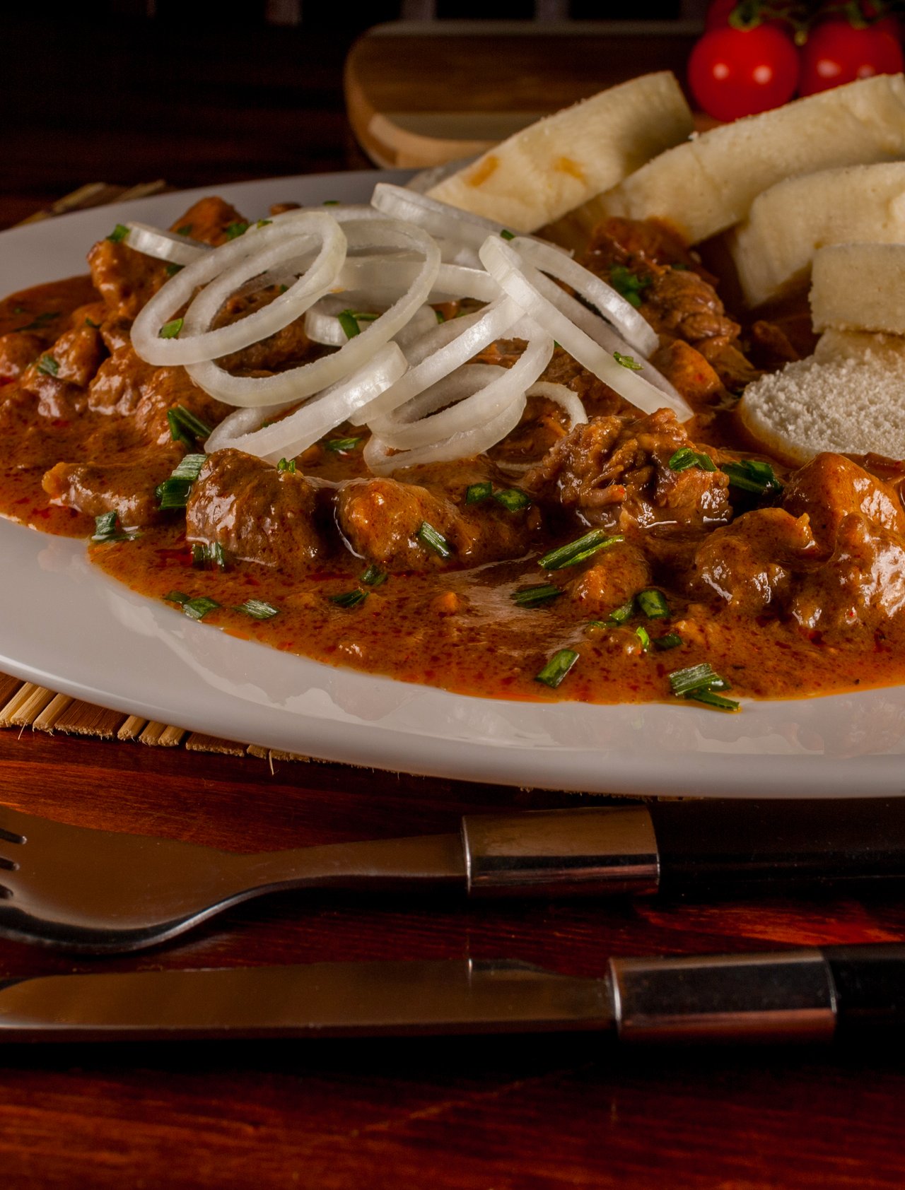 A plate of Czech goulash with dumplings