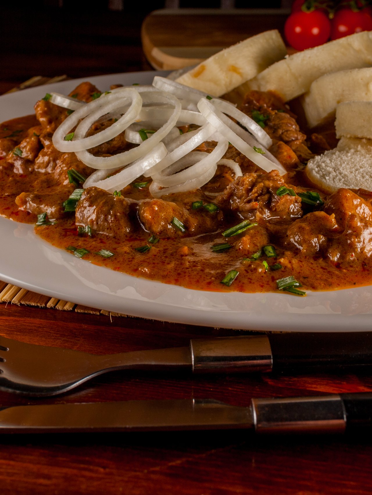 A plate of Czech goulash with dumplings
