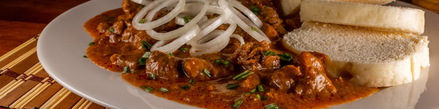 A plate of Czech goulash with dumplings