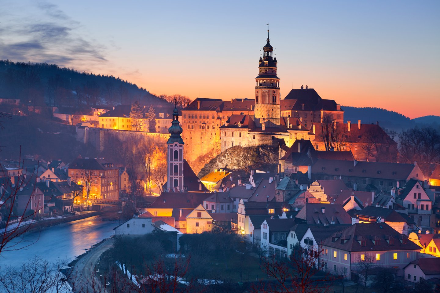 Český Krumlov Castle looming over the town at twilight