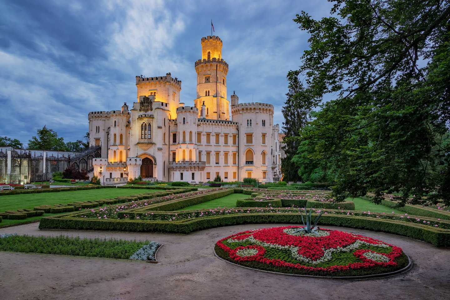 Hluboka Castle at night with flowering gardens