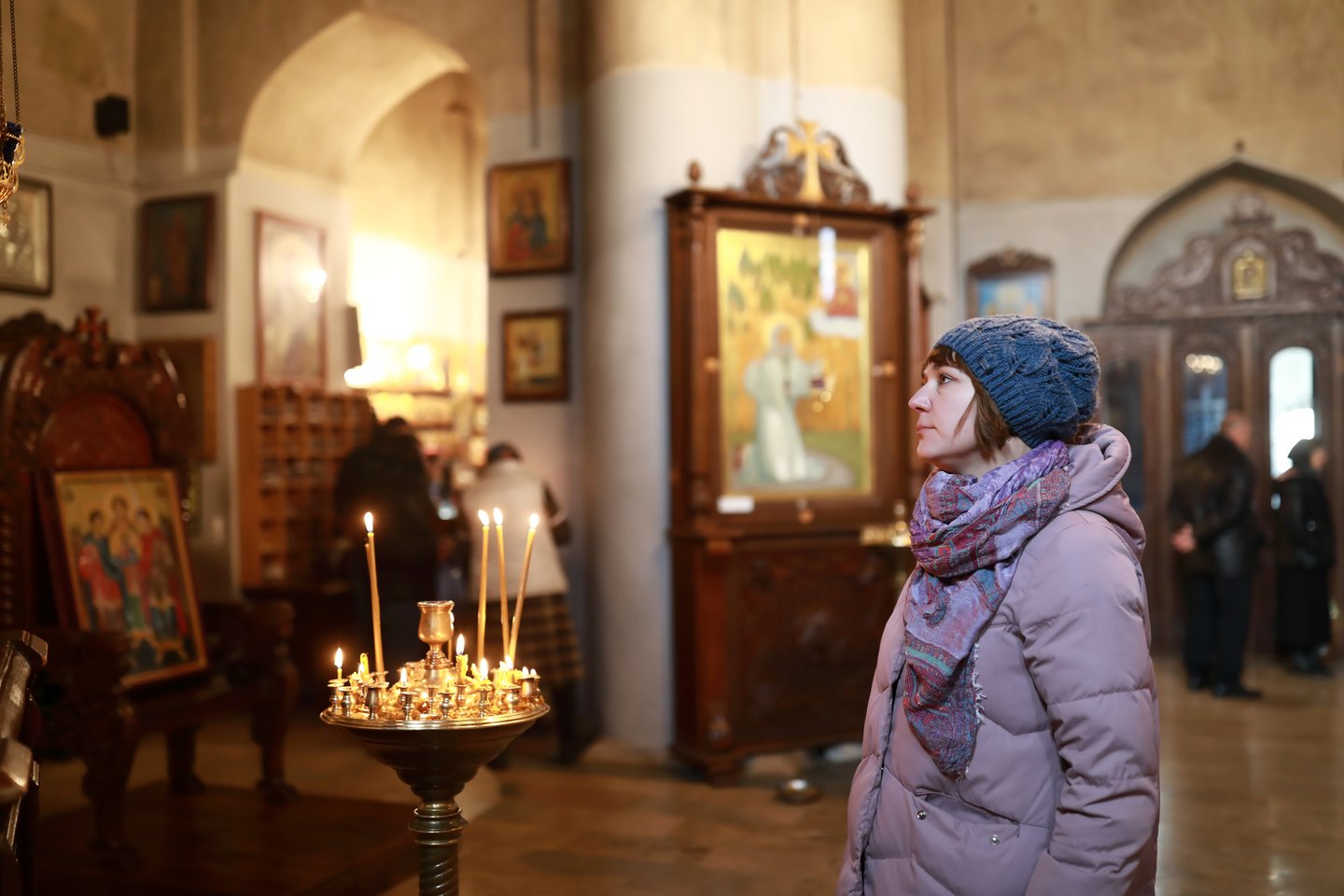 A woman lights a candle in a church during Easter services in Georgia