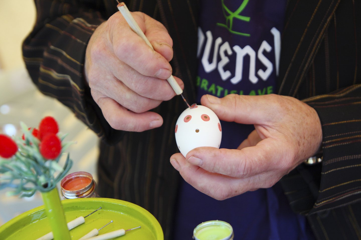 Carefully painting patterns on eggs