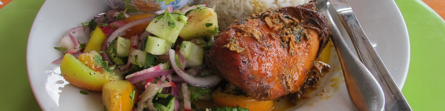 A typical Belizean lunch with salad, stew chicken and beans and rice