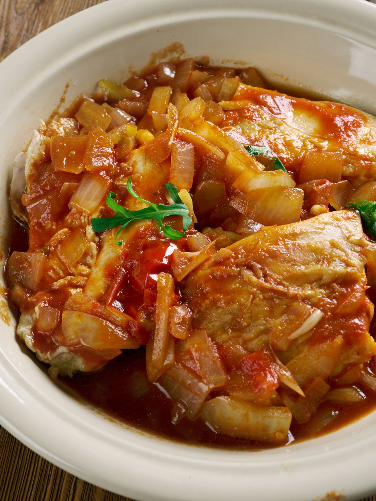 Belize-style stew chicken made with chicken and tomatoes