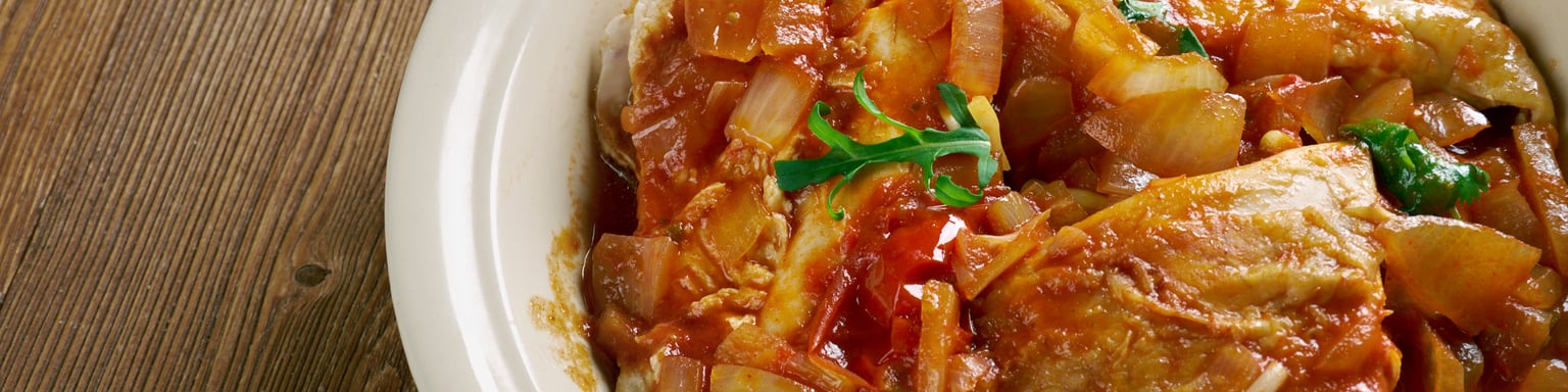 Belize-style stew chicken made with chicken and tomatoes