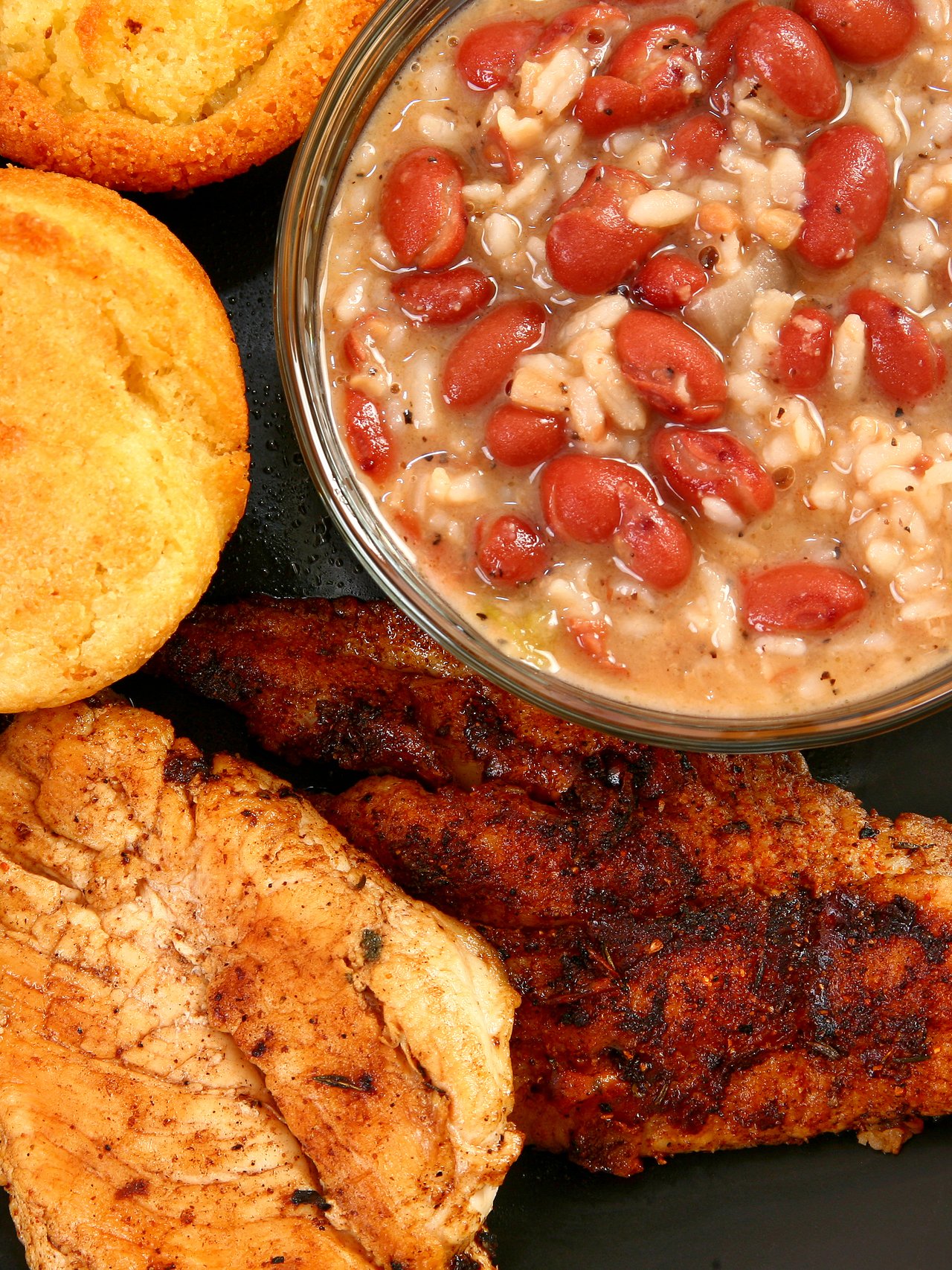 A platter of Cajun food including fish and red beans and rice